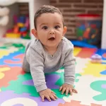 Baby Steps Infant Care Skipwith Academy - image of baby crawling on colorful mat