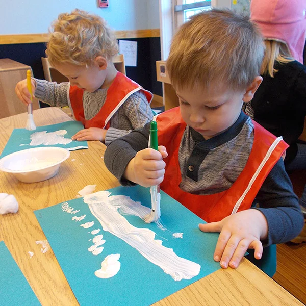 Skipwith Academy Preschool Explorers - boys in smocks painting together