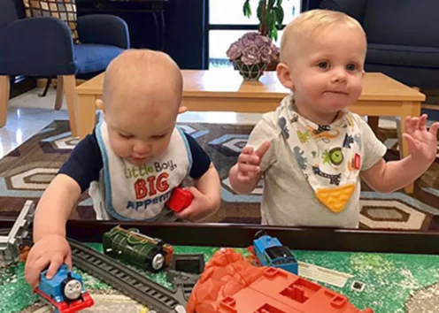 Toddler Daycare early childhood learning preschool - two young boys playing with toys on small table