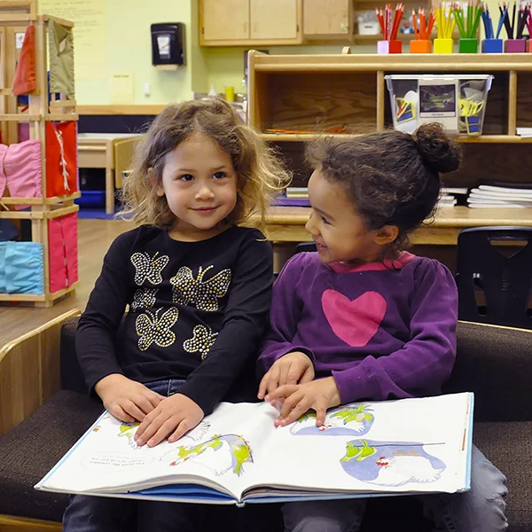 Skipwith Academy PREP Enrichment - two girls laughing and reading together