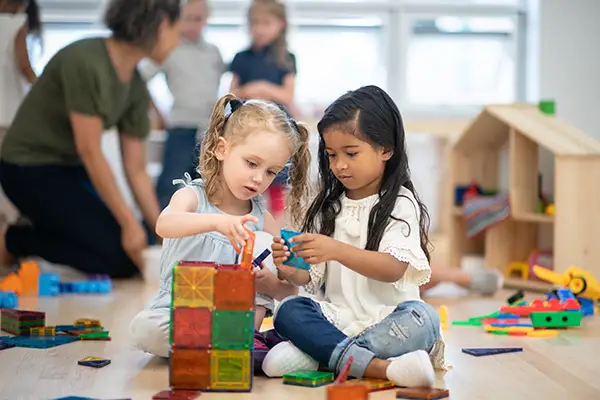 Skipwith Academy Montessori - girls building together with shape blocks