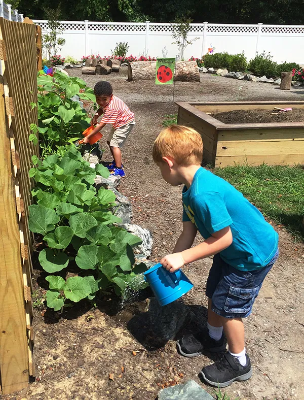 Skipwith Academy Richmond VA Summer Camp - boys watering garden outside