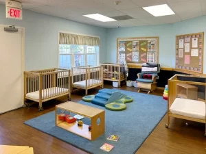 Skipwith Academy at Hanover - childcare in Ashland, Virginia, near Richmond - baby steps room featuring cribs, rocking chair, and toys for infants